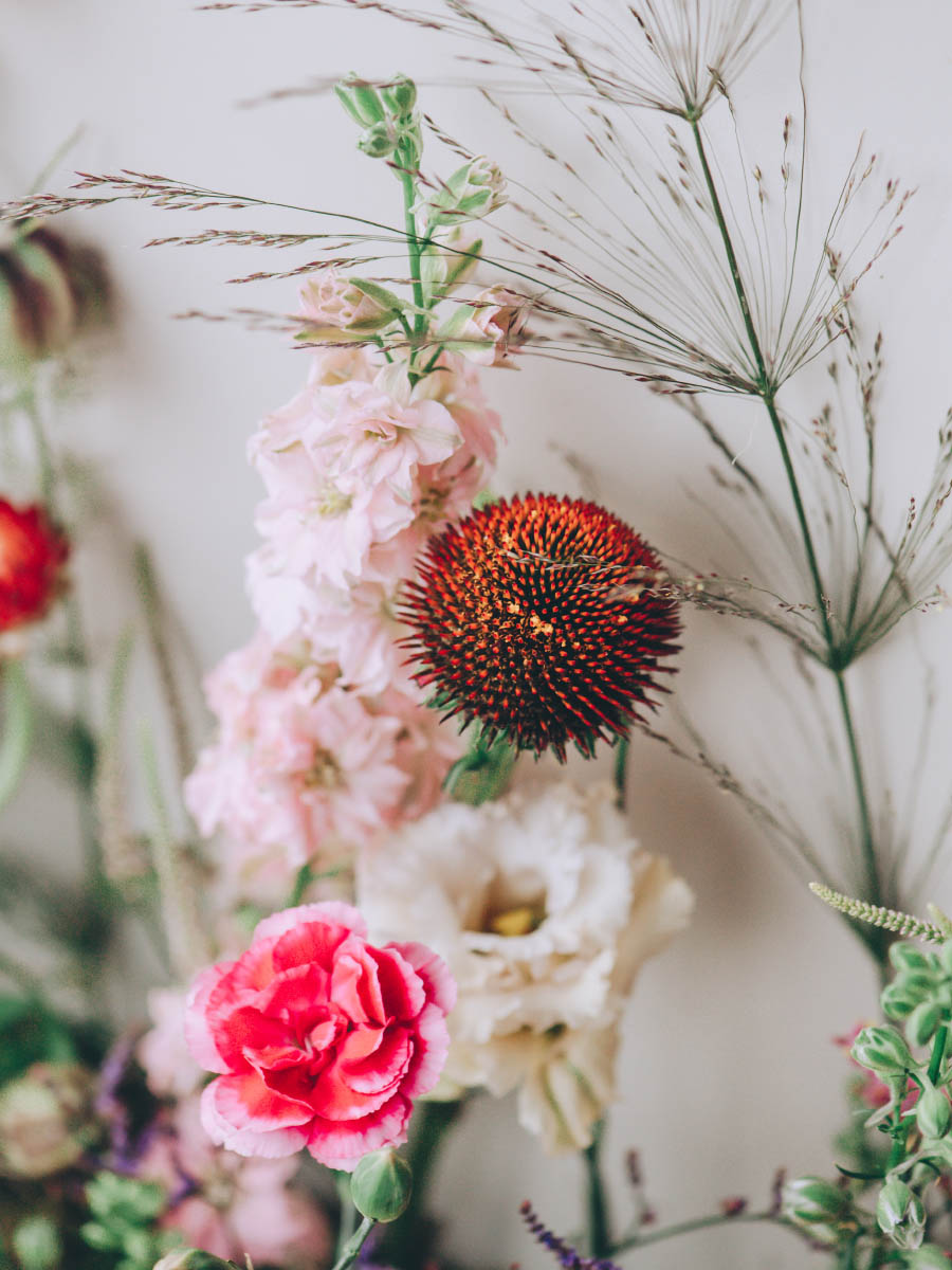 A stunning floral backdrop for a same-sex wedding at Trevenna in Cornwall.