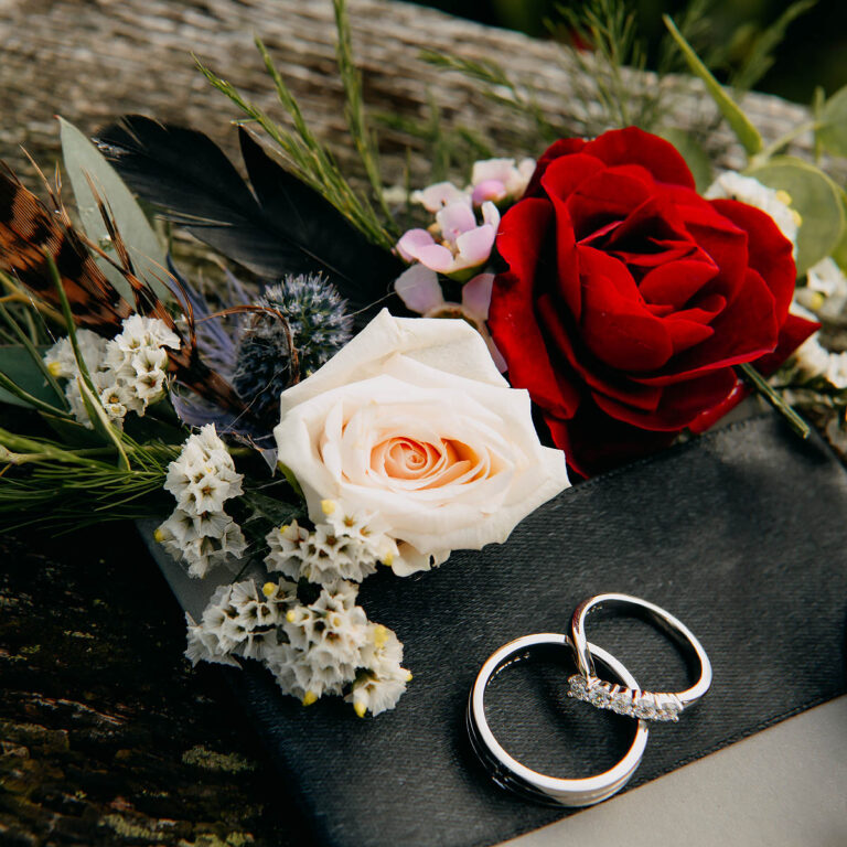 An elegant pocket square of roses and field flowers accented with a pheasant feather. Created by Artem Florum for a Gothic-inspired wedding at Trevenna Barns, Cornwall.