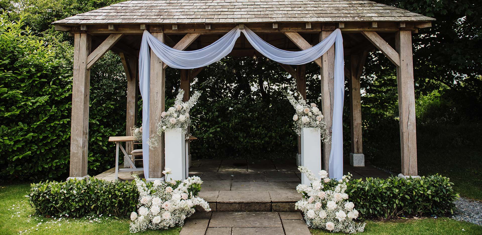 Elegant white bridal bouquet of roses designed by Artem Florum for a wedding in Devon.